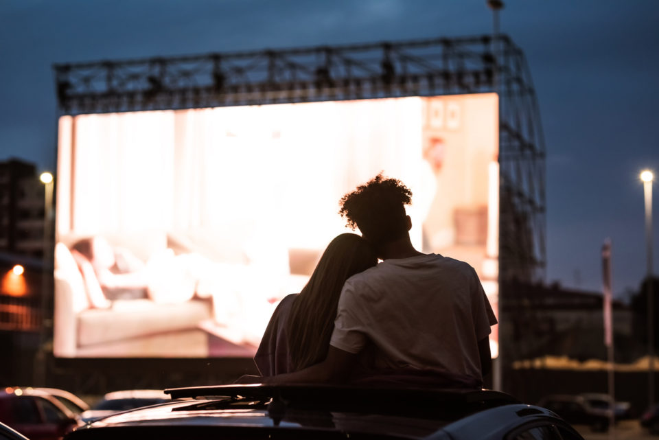 young couple at drive in movie