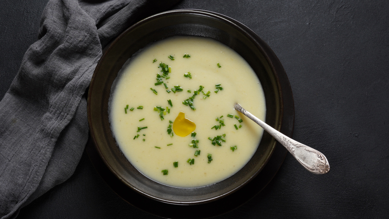 Vichyssoise, classic French chilled cream soup - potato leek, and onion topped with chopped chives